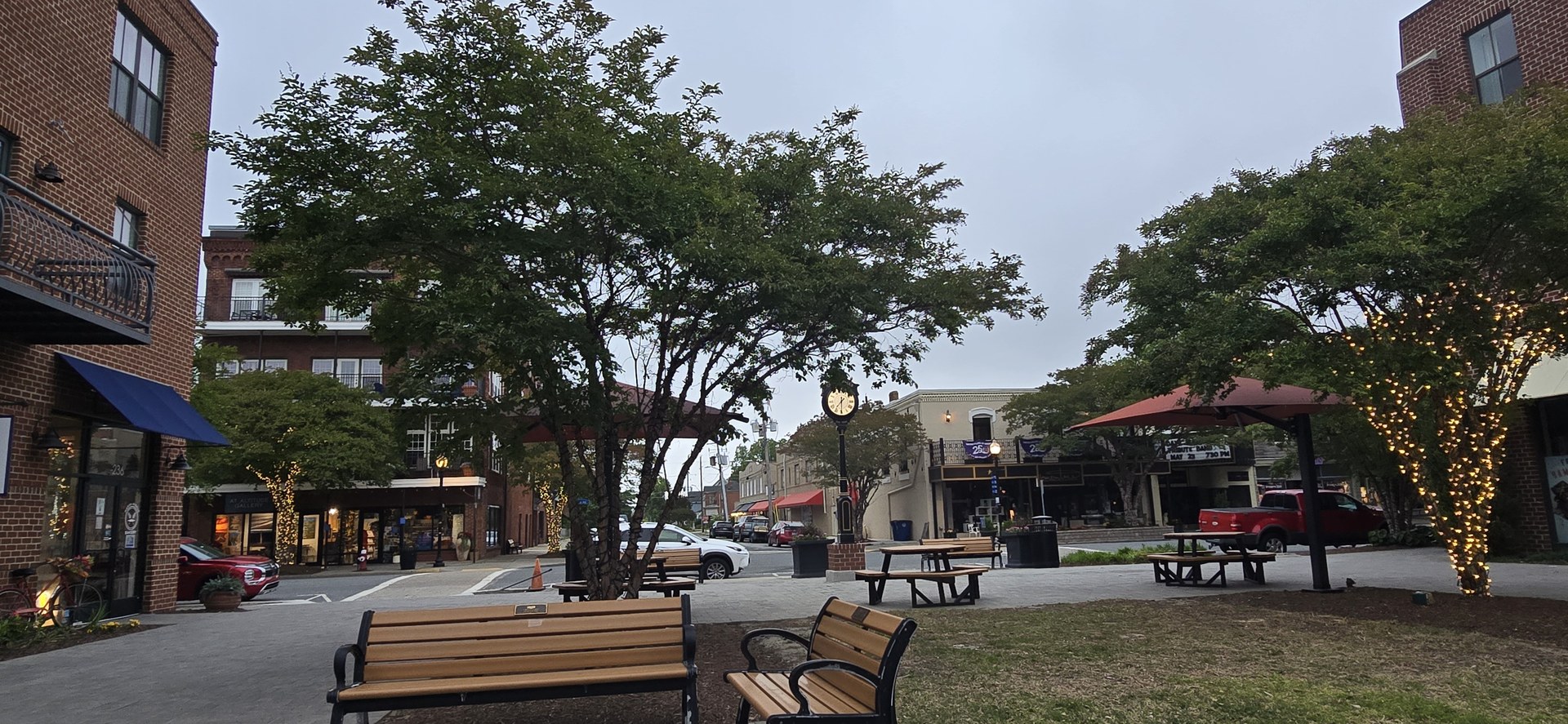 Cape Charles town square with benches and string lights Cape Charles town square with benches and string lights