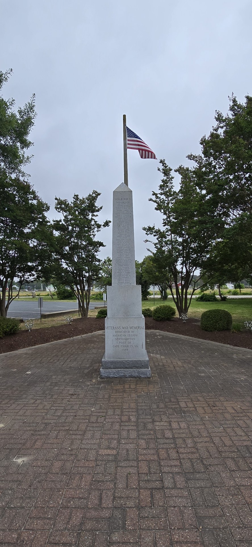 A monument and flag on a brick walk in Cape Charles A monument and flag on a brick walk in Cape Charles
