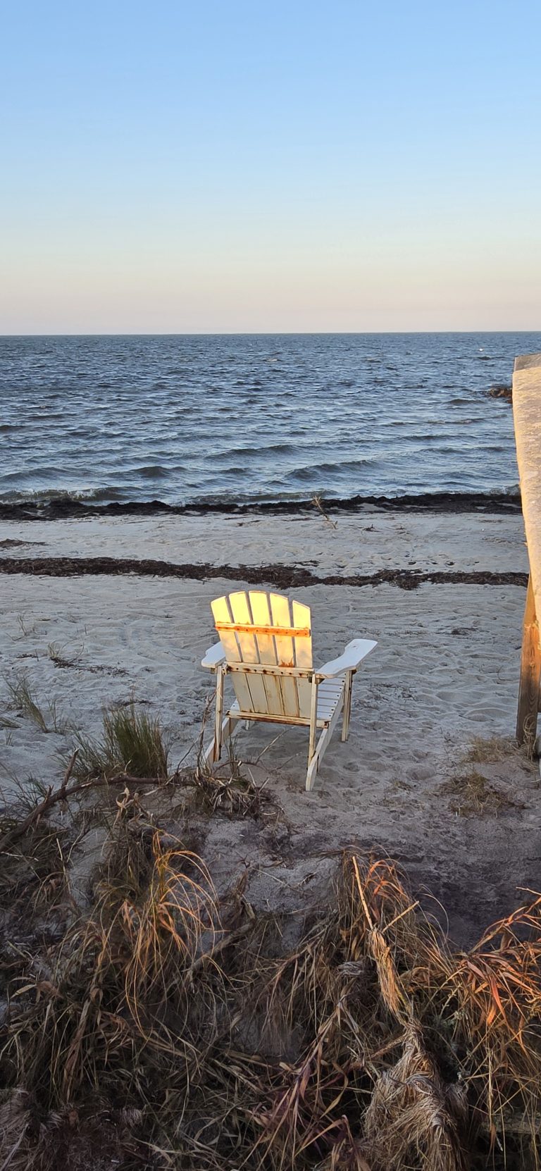 An empty beach chair facing the sound in Rodanthe, North Carolina.