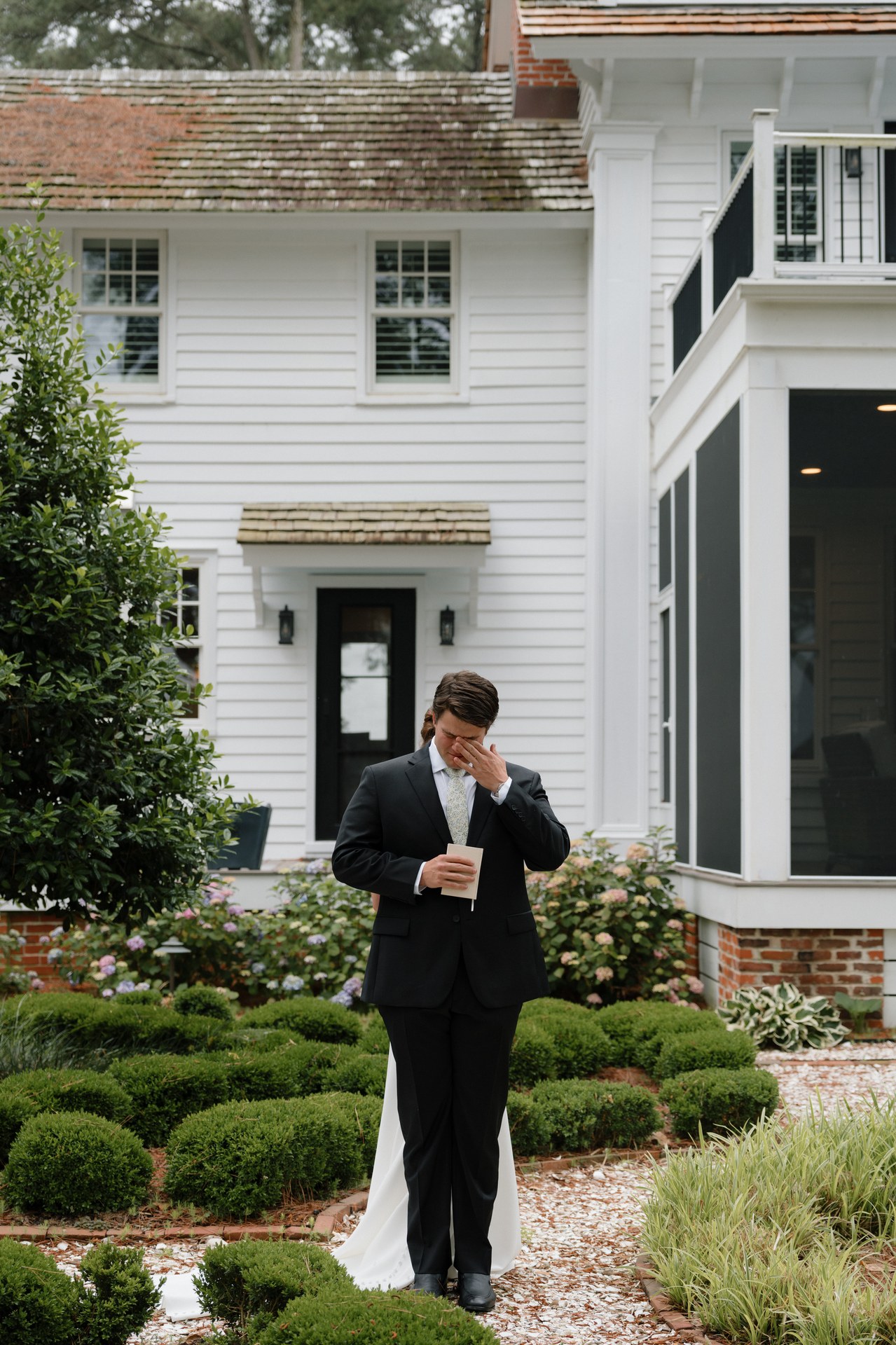 A groomsman waiting alone by the water in the mist A groomsman waiting alone by the water in the mist