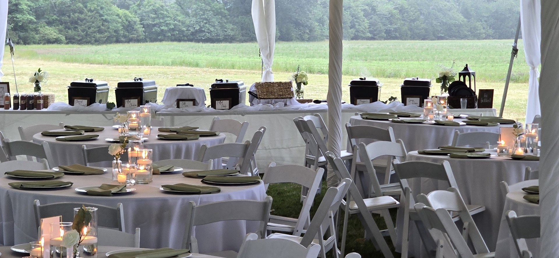 Candlelit reception tables glowing at dusk Candlelit reception tables glowing at dusk